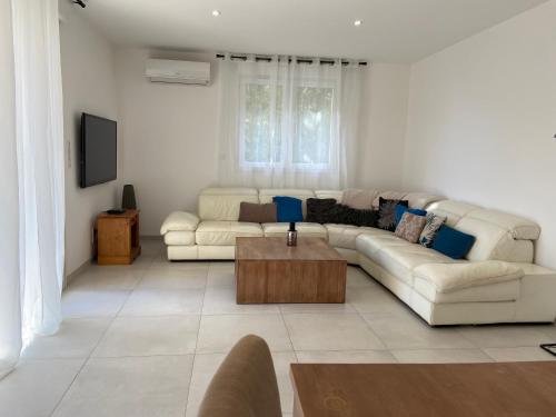 a living room with a couch and a table at Casa Laura in Cervione