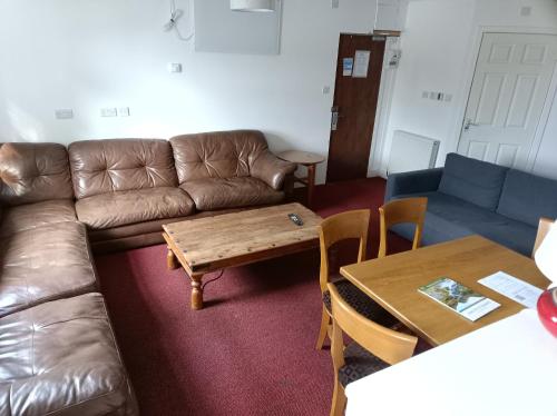 a living room with a couch and a table at The Townhouse Self Catering in Dumfries