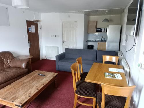 a living room with a table and a couch at The Townhouse Self Catering in Dumfries