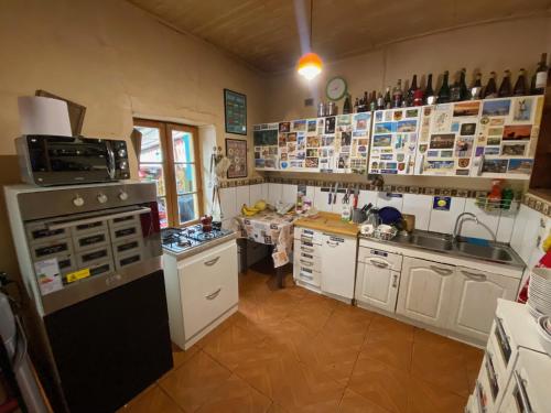 a kitchen with white cabinets and a stove top oven at Hostal Kuyen in Pichilemu