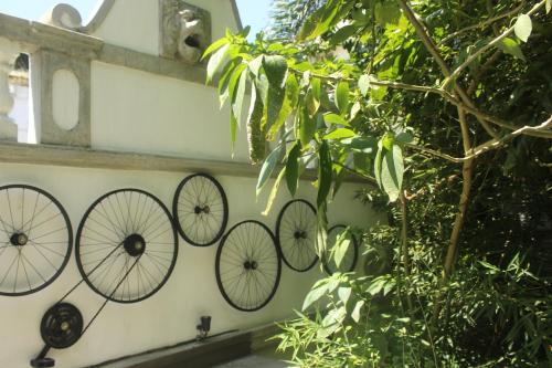 a wall with four bicycle decorations on it at Villa Olde Ceylon in Kandy