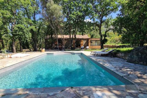 - une piscine avec un banc et une maison dans l'établissement Villa Bergerie Baracco Argia, piscine, maquis et tradition corse pour 6 personnes, à Barbaggio