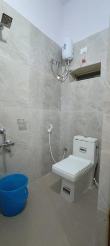 a bathroom with a toilet and a sink at RK RESIDENCY in Kothakota