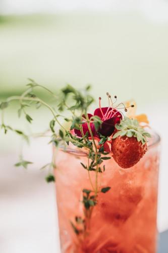 a glass vase with a strawberry in it at Hotel Spiaggia d'Oro - Charme & Boutique - Garda Lake Collection in Salò