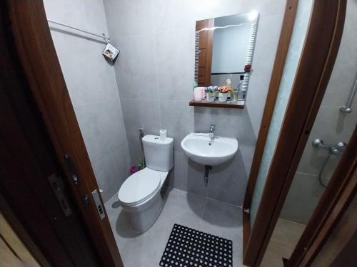 a bathroom with a toilet and a sink at Sri Studio 07@Pollux Habibie Meisterstadt in Batam Center