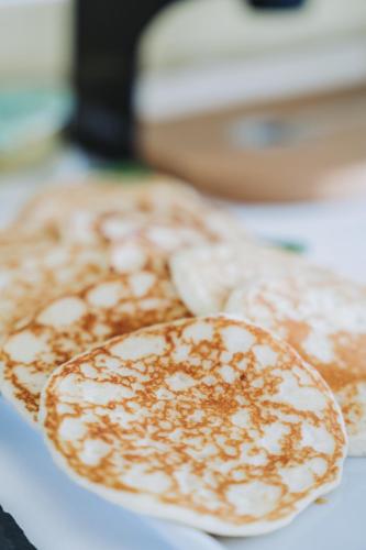 a plate of pancakes with nuts on top of it at Hotel Spiaggia d'Oro - Charme & Boutique - Garda Lake Collection in Salò