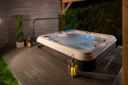 a jacuzzi tub on the deck of a house at Knipoch House Hotel in Oban