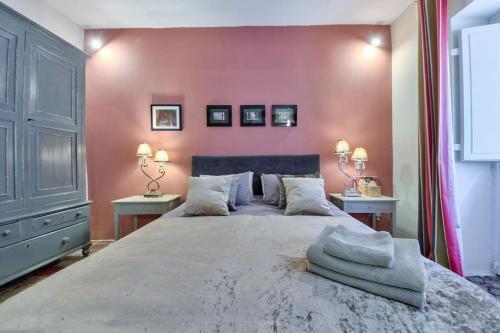 1 dormitorio con 1 cama grande y paredes de color rosa en Designer Cospicua Townhouse, en Cospicua
