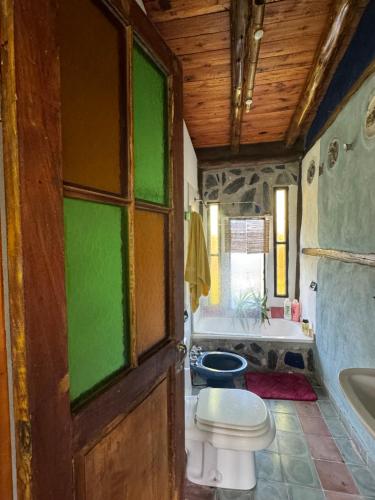 a bathroom with a toilet and a bath tub at Bed and Breakfast near the Airport in Ezeiza