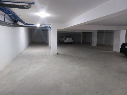 an empty garage with a car parked in it at Panoramique appartement in Kenitra