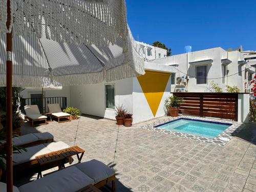 un patio con piscina y una casa en La Mona Loiza, en San Juan