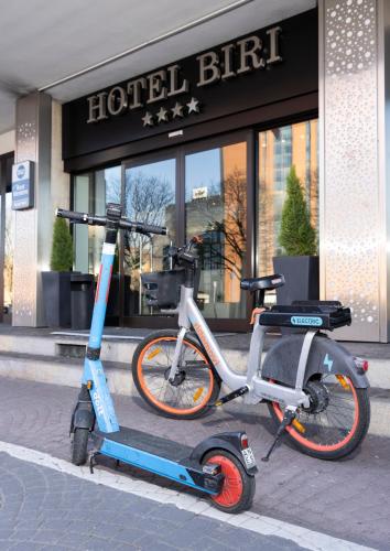 two scooters are parked in front of a building at Best Western Hotel Biri in Padova