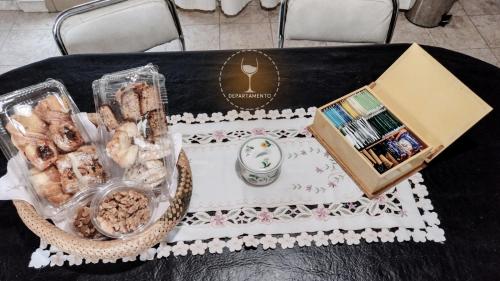 una mesa con una bandeja de comida y una caja en Malbec Departamentos en Maipú