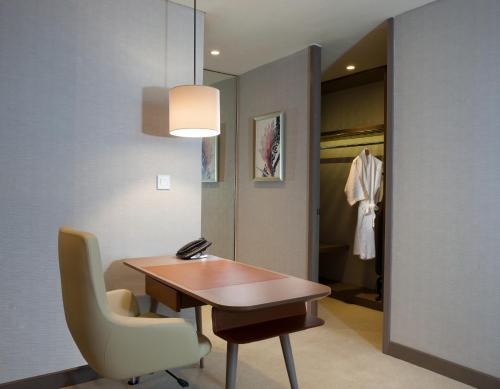 a room with a table and a chair and a closet at InterContinental Bandung Dago Pakar by IHG in Bandung