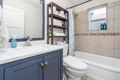 a bathroom with a sink and a toilet and a tub at Charm City Hideout 2bdr and Basement in Indianapolis