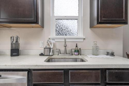 a kitchen with a sink and a window at Charm City Hideout 2bdr and Basement in Indianapolis