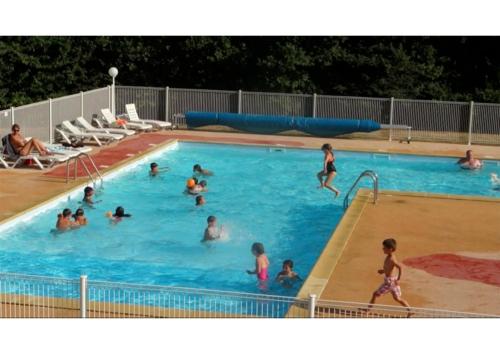 a group of people in a swimming pool at Le village de Sèchemailles in Ambrugeat