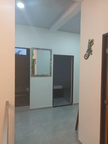 a room with a mirror and a motorcycle on the wall at Villa con piscina privada y zona bbq en condominio in Carmen de Apicalá