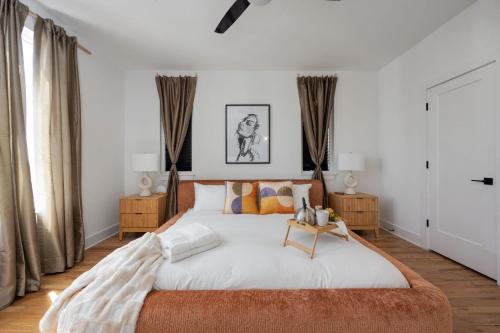 1 dormitorio con 1 cama grande con paredes y cortinas blancas en En-Vogue Vacay - Rooftop Deck - 4 mins to TSU en Nashville