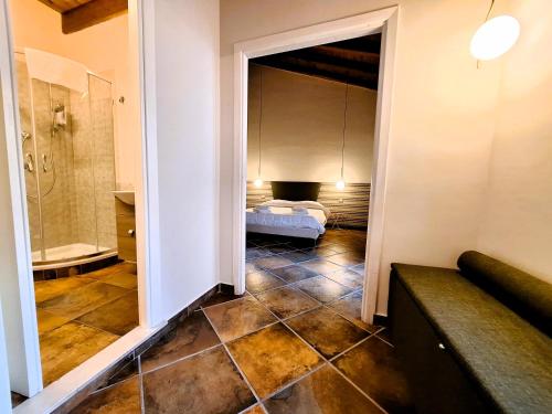 a room with a bedroom with a bed and a bathroom at Casa Aretusa - Ortigia Holidays in Syracuse