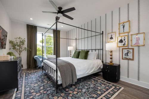 a bedroom with a canopy bed and a fan at Southern & Style-2 Townhomes-7 Mins To Broadway in Nashville
