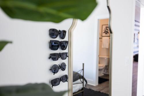 a bunch of sunglasses hanging on a wall at Southern & Style-2 Townhomes-7 Mins To Broadway in Nashville
