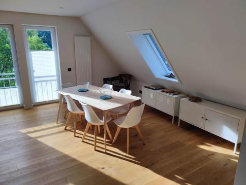 a dining room with a white table and chairs at Ferienwohnung an der Wassermühle in Hermannsburg in Hermannsburg