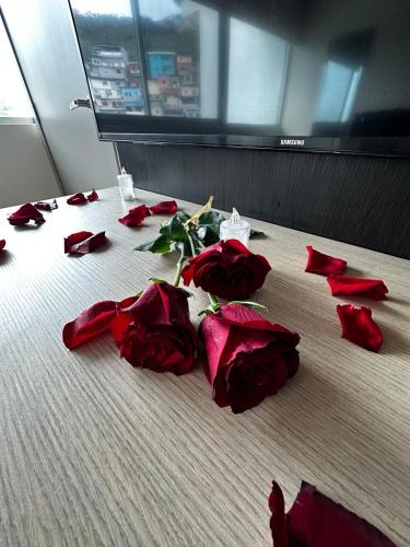 a group of red roses laying on a bed at Depa de lujo con piscina y jacuzzi in Guayaquil