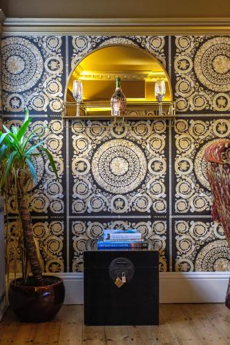 a room with a wall with a yellow and blue tiles at Huge Deluxe 600 Year Old Essex Manor, Hot Tub, Cinema Room, Sky Tv in Saffron Walden