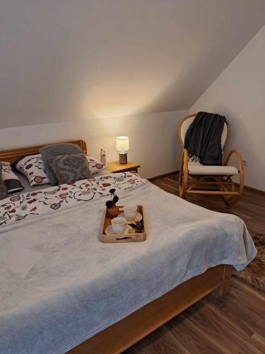 a bedroom with a bed with a tray of food on it at Zakątek Pienin in Grywałd