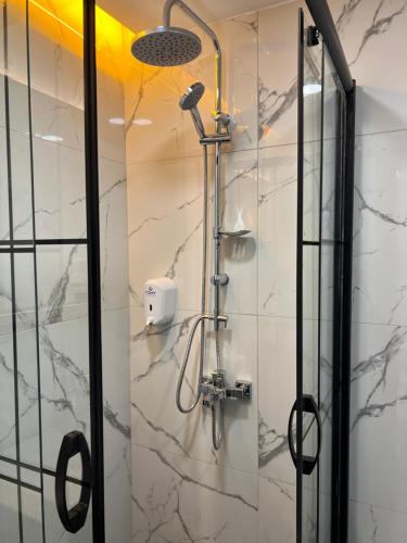 a shower in a bathroom with a glass door at The Blue Suites in Istanbul