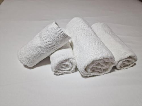 a group of white towels sitting on a table at Deluxe 1-Bed Apartment in Greenford in Greenford