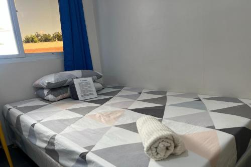 a bedroom with a bed with a checkered floor at Happy Grey Hotel Vigan in Vigan