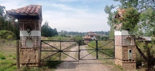 an entrance to a house with a gate at El Encanto De La Villa Campestre in Villa de Leyva