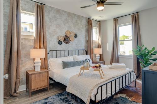 a bedroom with a large bed and two windows at Nashville - 5631 Lenox Ave in Nashville