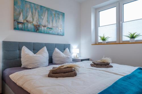 a bedroom with a large bed with two pillows on it at App 7u Erholsamen Sundowner in Dranske
