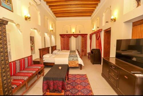 a hotel room with two beds and a television at Naket royal guest house in Accra