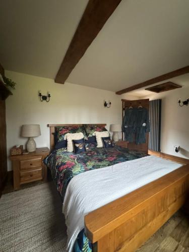 a bedroom with a large bed with a wooden frame at Fox Hill in Brompton