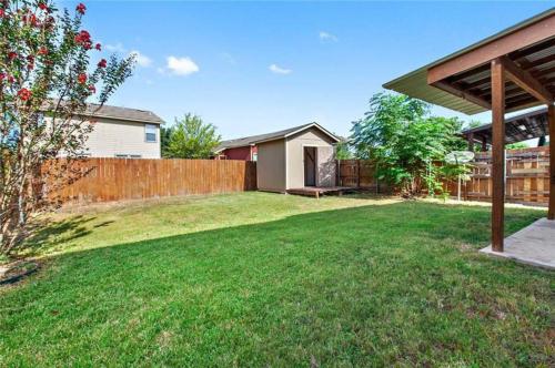 a backyard with a wooden fence and a house at Cozy Home Near Downtown Austin And Airport in Austin