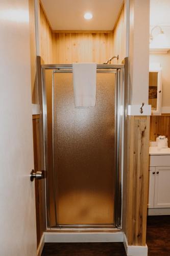 a shower in a bathroom with a stainless steel refrigerator at Carriage House Country Club in Pocono Manor