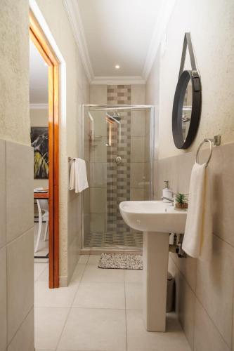 a bathroom with a sink and a shower at Lions View Accommodation in Nelspruit