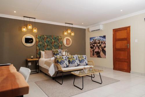 a living room with a bed and a couch at Lions View Accommodation in Nelspruit