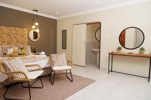 a bathroom with a tub and a sink and a mirror at Lions View Accommodation in Nelspruit