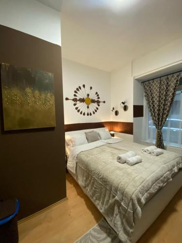 a bedroom with a large bed with two towels on it at Allaga City Center in Budapest