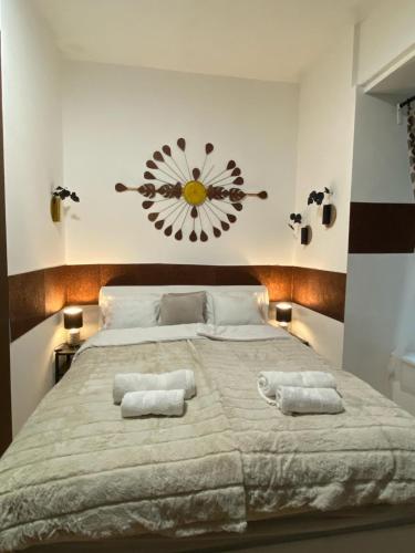 a bedroom with a large bed with two towels on it at Allaga City Center in Budapest