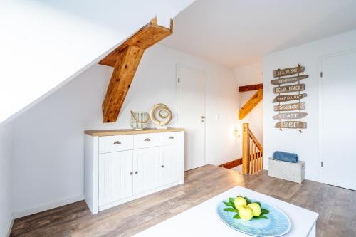 a room with a white chest of drawers and a staircase at Strand Familien Doppelhaushälfte ,,INGER'' #Familien-Treffen in Rappin