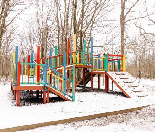 a colorful playground in a snow covered park at Carriage House Country Club in Pocono Manor