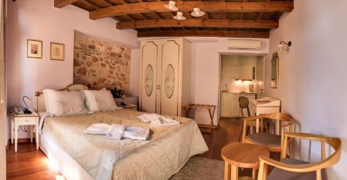 a bedroom with a bed with two towels on it at Palazzo Duca in Chania Town