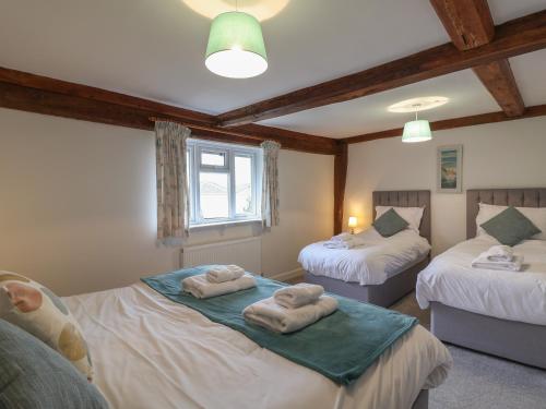 a bedroom with two beds with towels on them at Bedingfield House, nr Debenham in Debenham