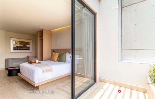 a bedroom with a bed and a glass wall at Casa Calderón by Kukun in Mexico City